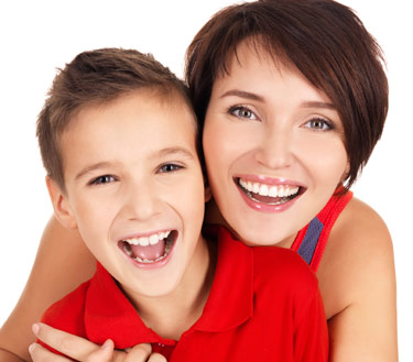 Mother and son smiling after teeth are fixed