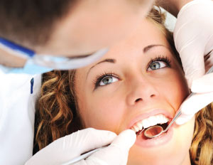 Dentist treating patient.