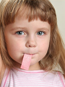 Kid chewing xylitol gum