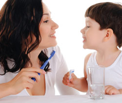 Mother and child brushing teeth.