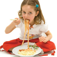 Child eating pasta.