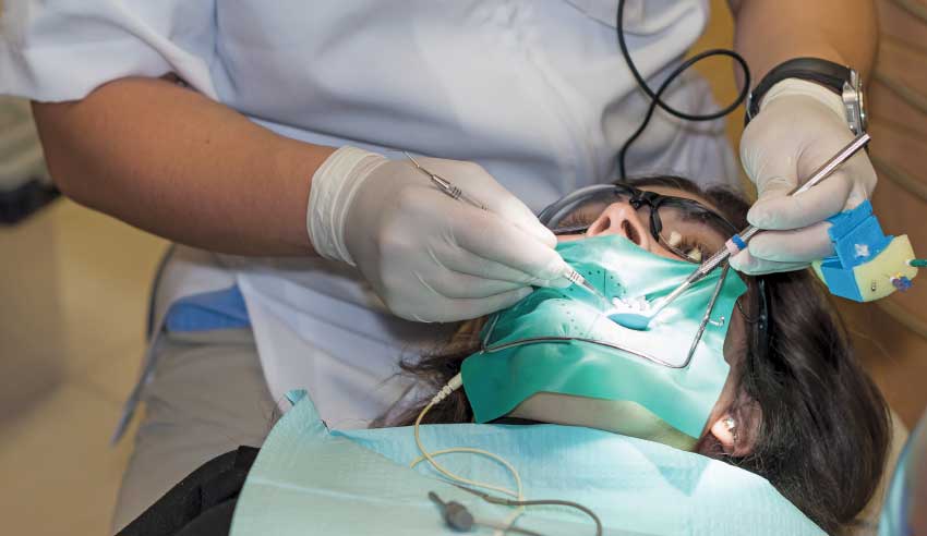 Endodontist performing root canal.