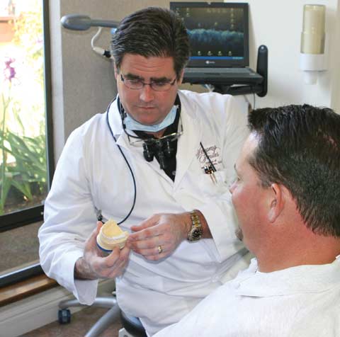 Dr. Wayne Sutton talking to patient.